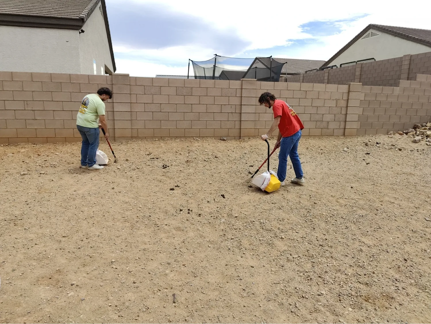 Scoop Doggy Logs team members scooping a Tucson backyard