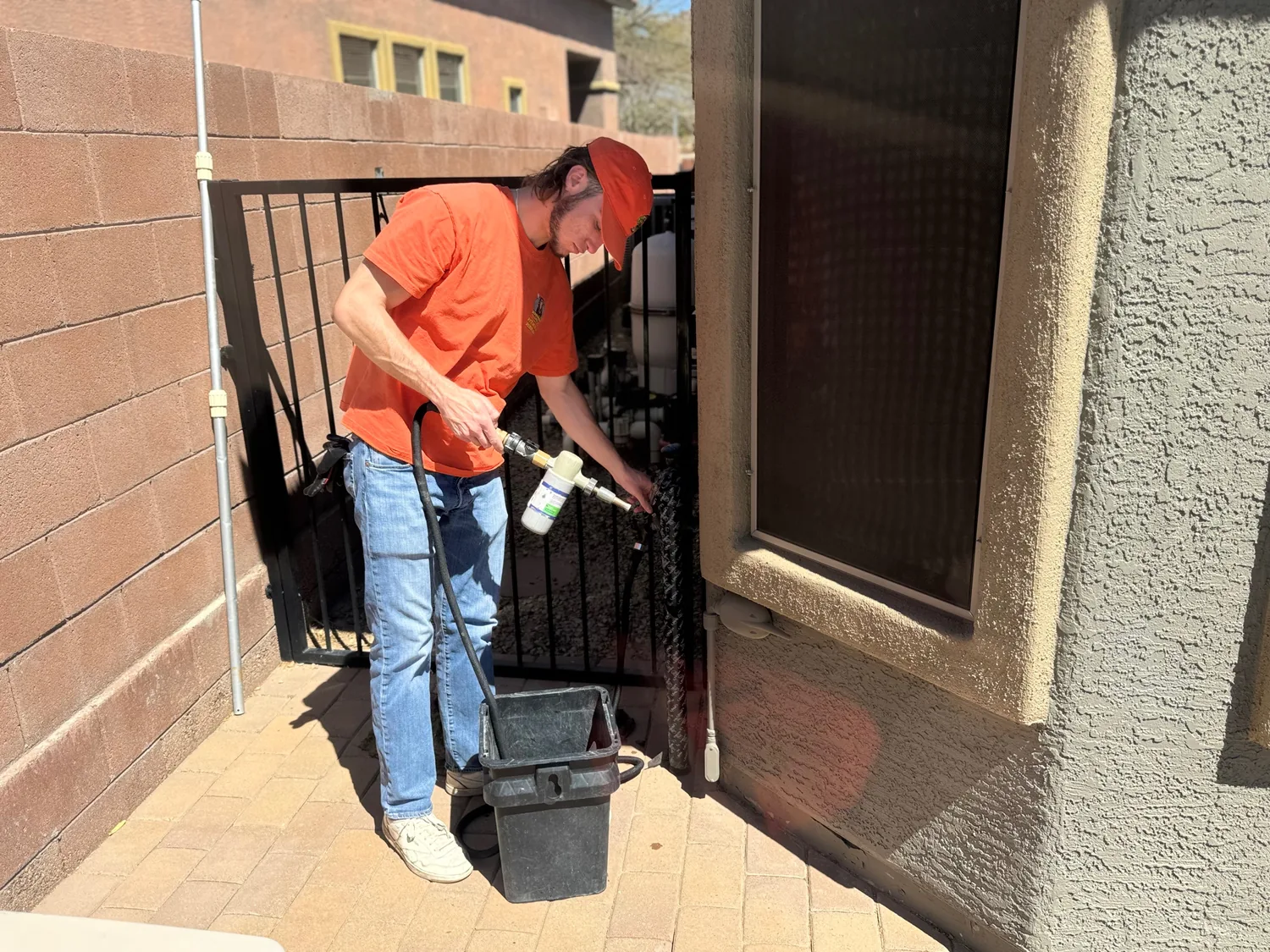 Team member spraying a Tucson turf yard