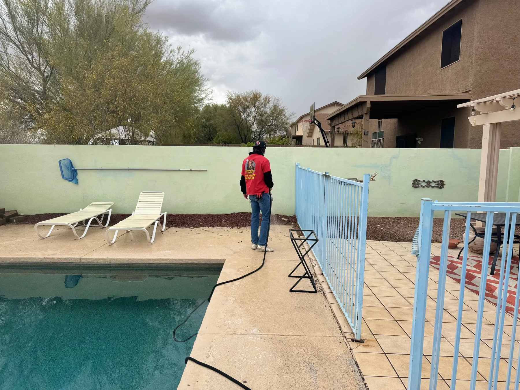 Scoop Doggy Logs crew member sanitizing a Tucson poolside yard